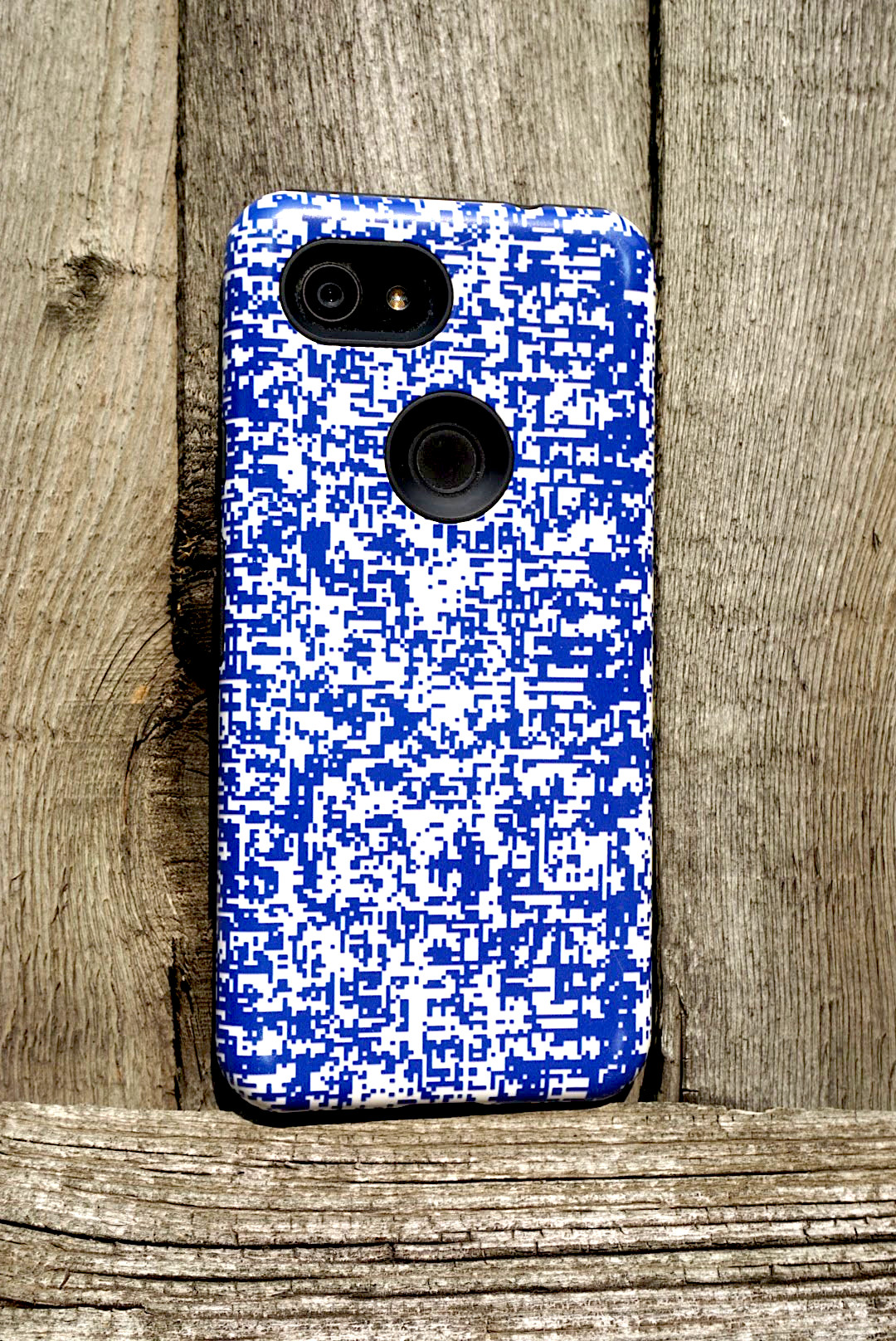 photo of a phone with a blue and white specked pattern on the case